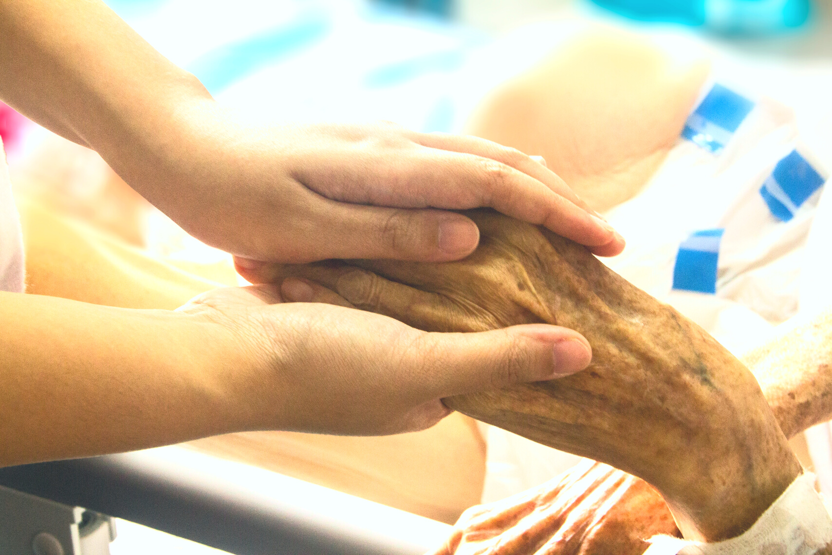 Person Holding the Hand of a Hospice Patient
